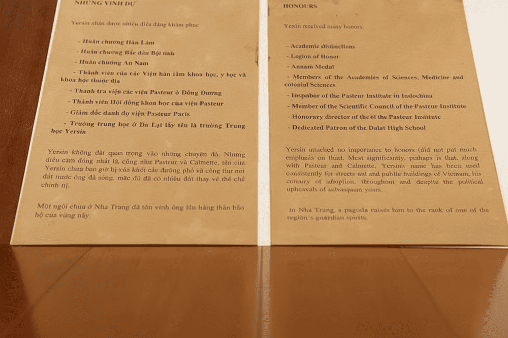 A bilingual display listing Alexandre Yersin’s numerous honors and his lasting legacy in Vietnam